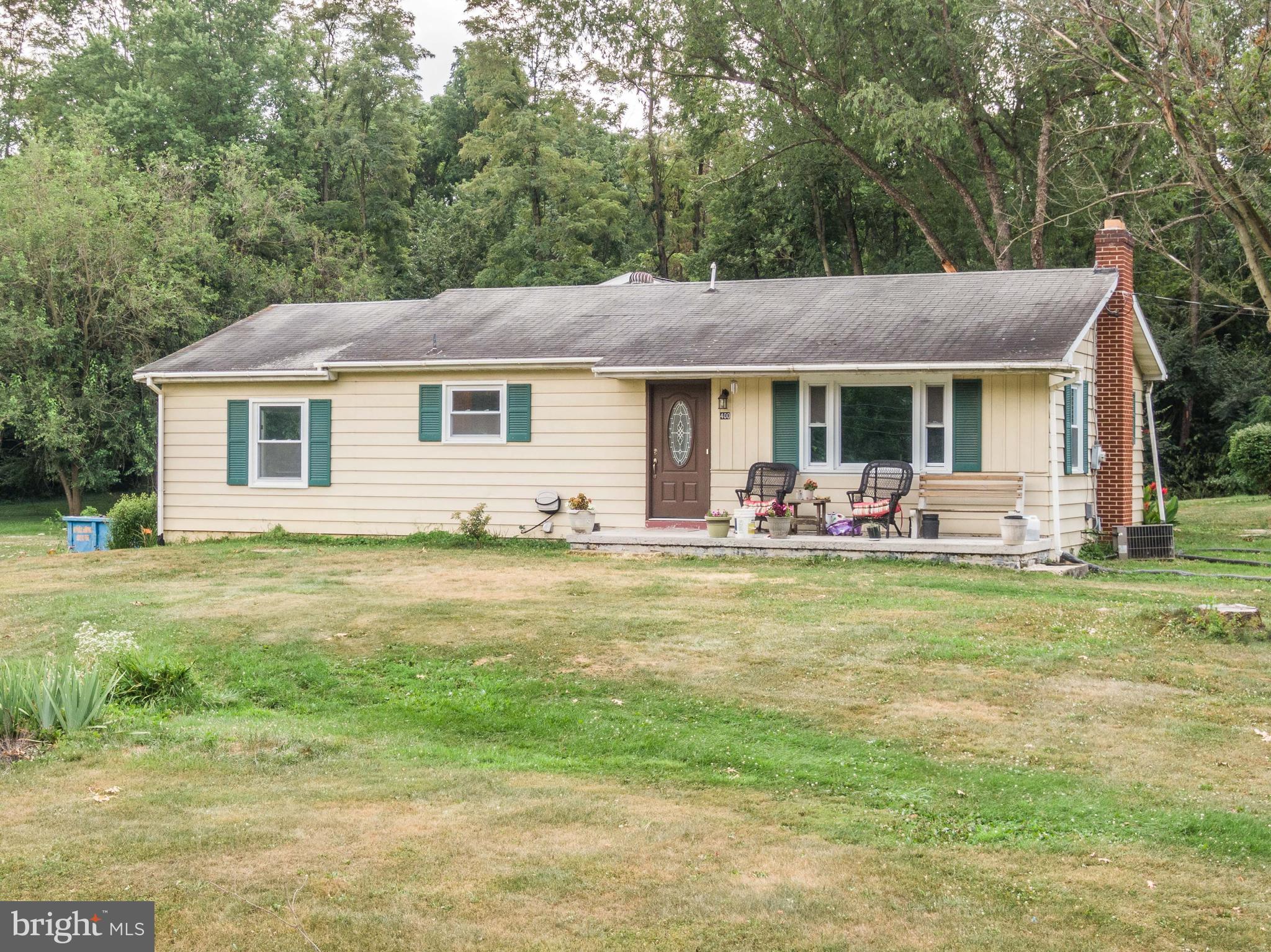 a front view of house with yard and green space