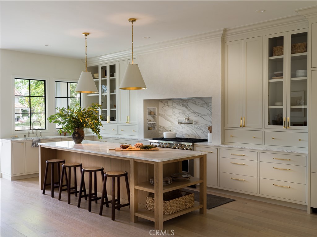 a kitchen with a stove and a wooden floor