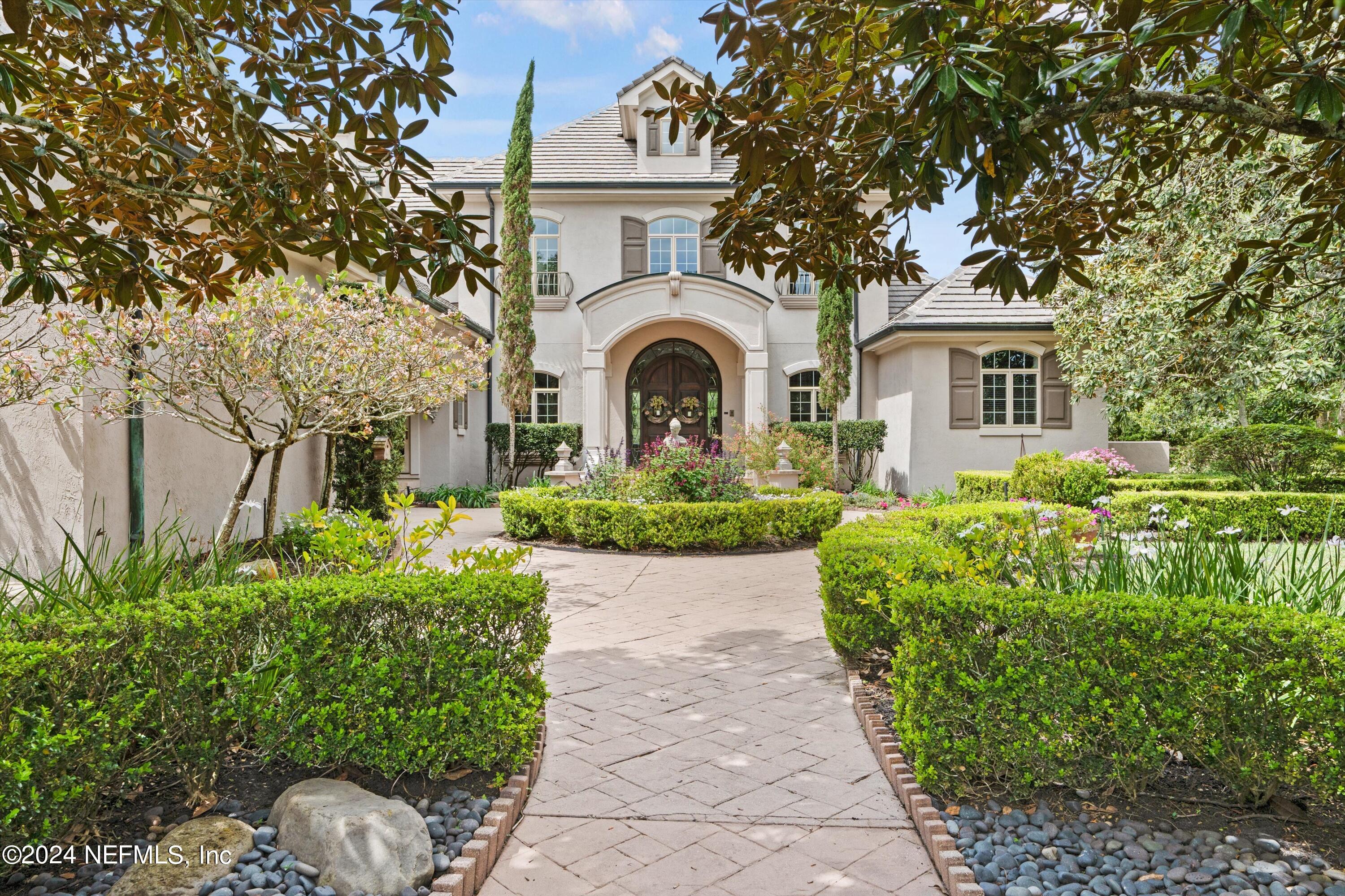 a front view of a house with garden