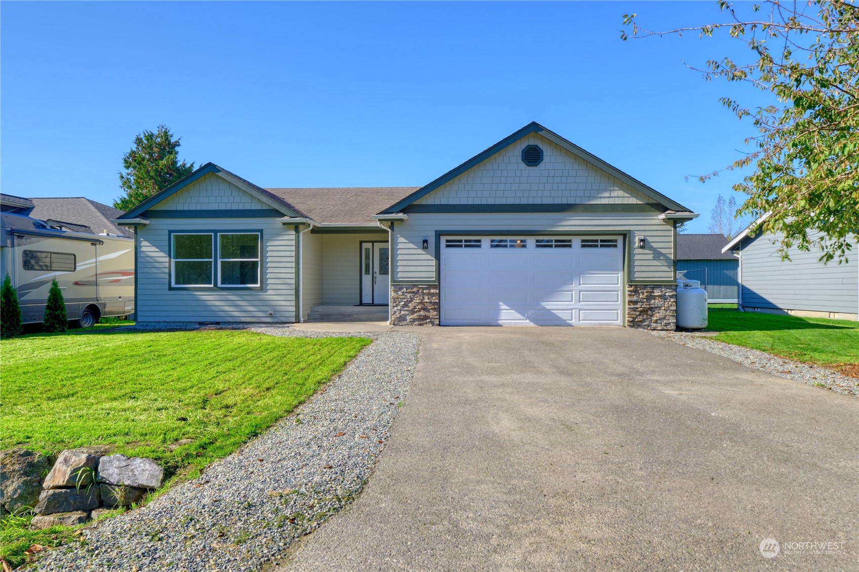 a front view of a house with a yard and garage