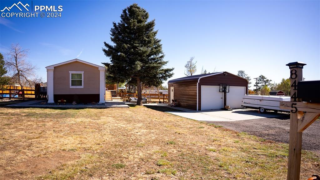 a front view of a house with a yard covered in snow