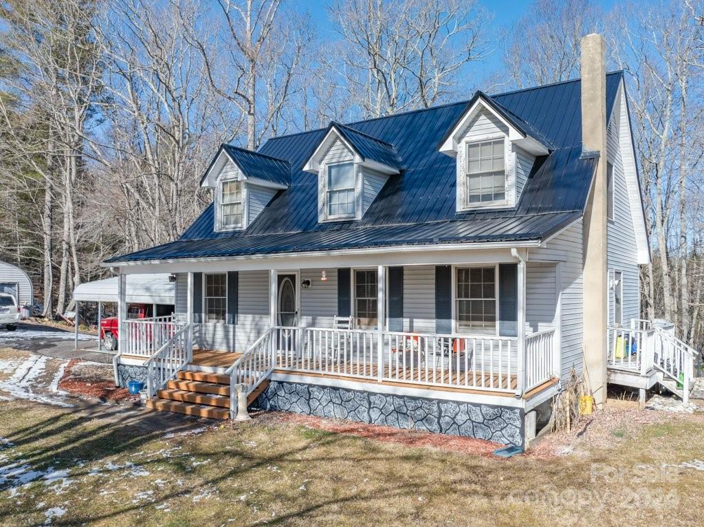 a front view of a house with a yard outdoor seating and barbeque oven