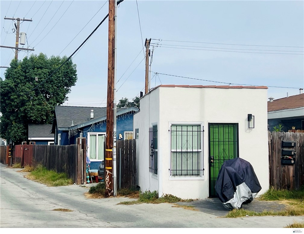 a view of a house with a patio and a yard