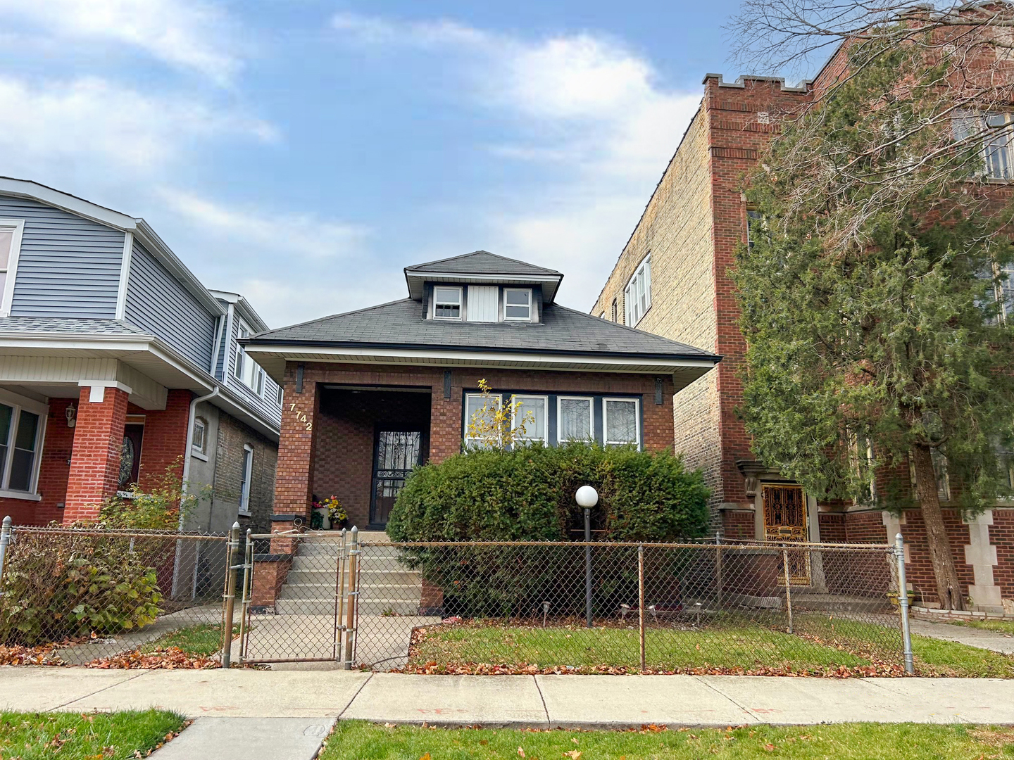 a front view of a house with a garden