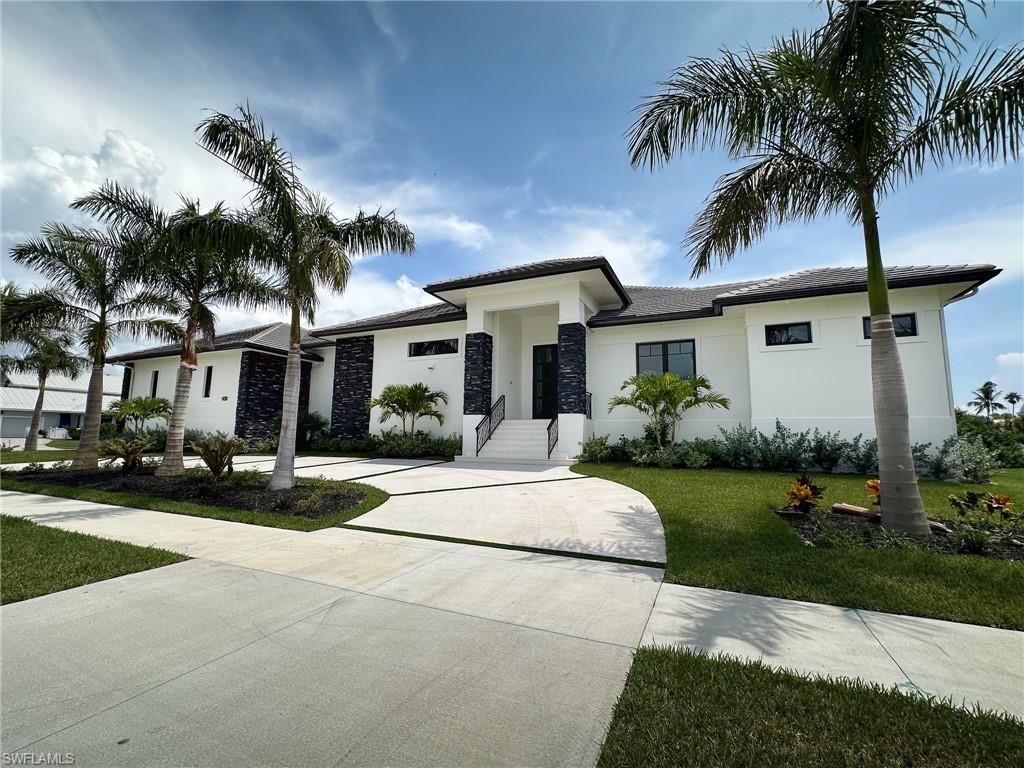 a white house with palm trees