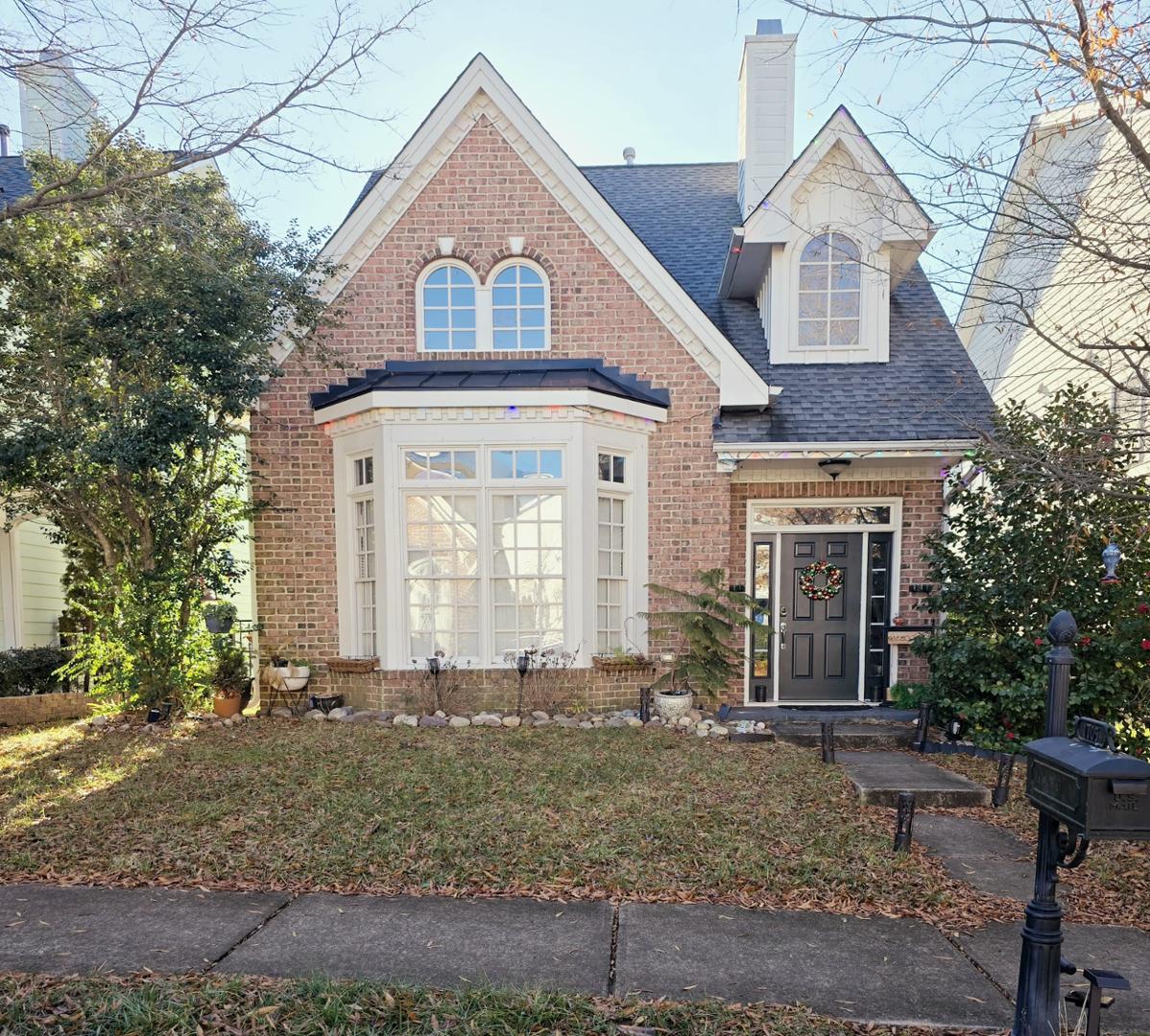 a front view of a house with garden