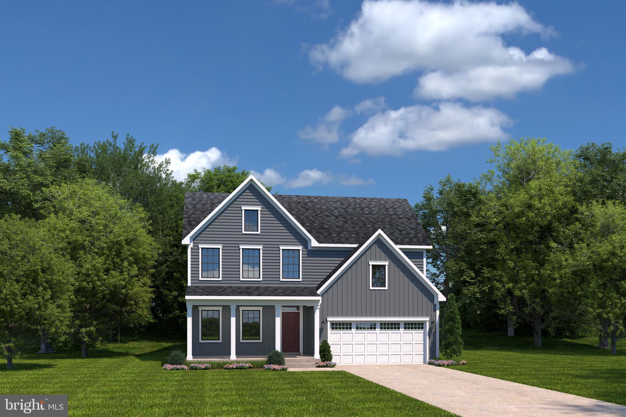 a front view of a house with a garden and trees