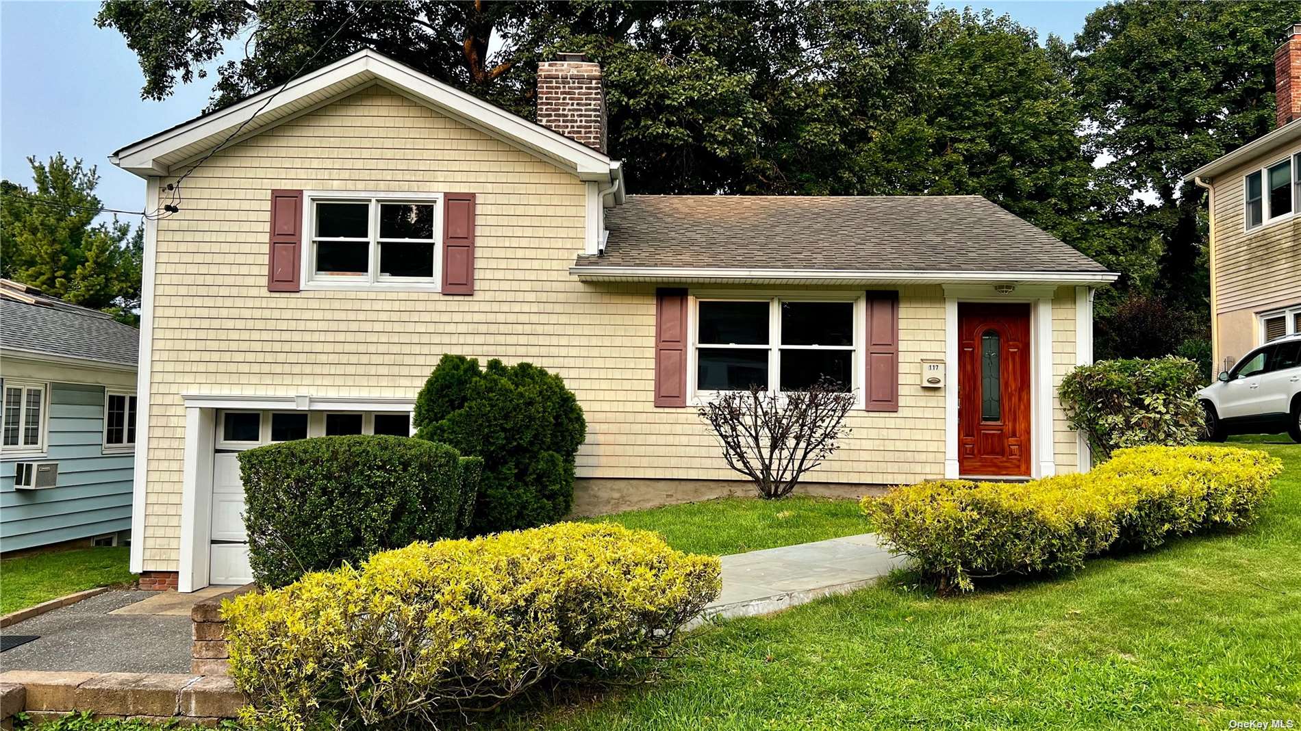 a front view of a house with garden