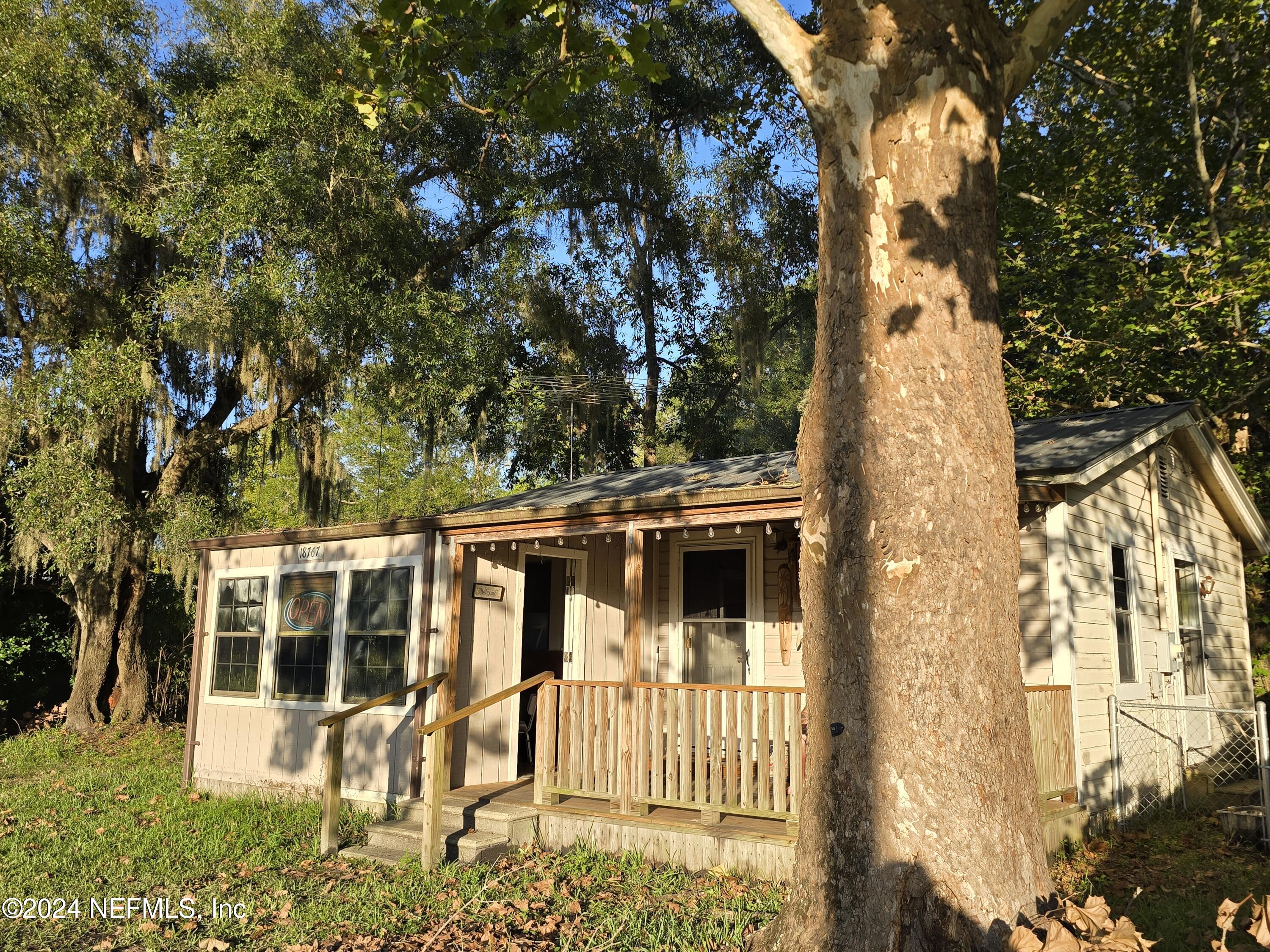 a view of a house with a tree