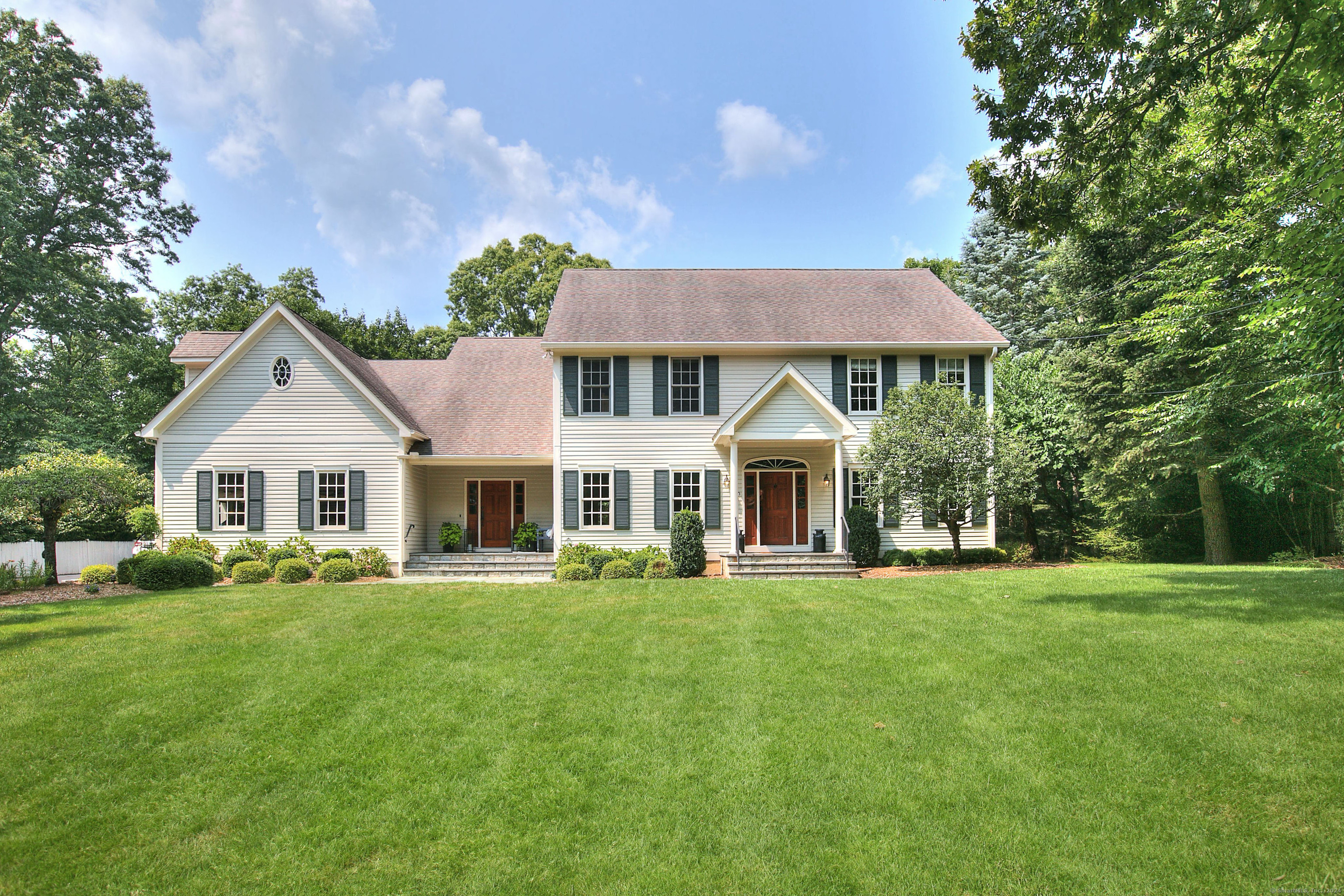 a front view of a house with a garden