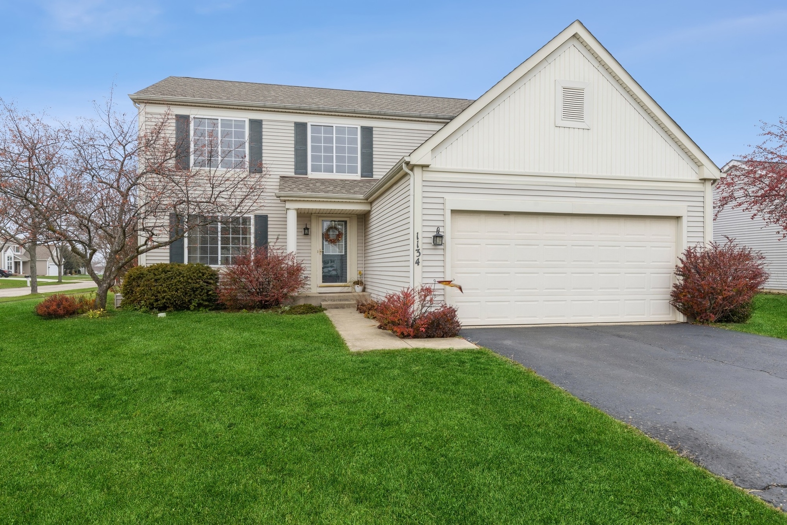 a front view of house with yard and green space