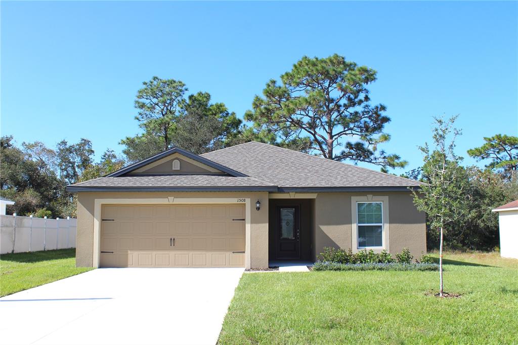 a front view of a house with a garden and yard