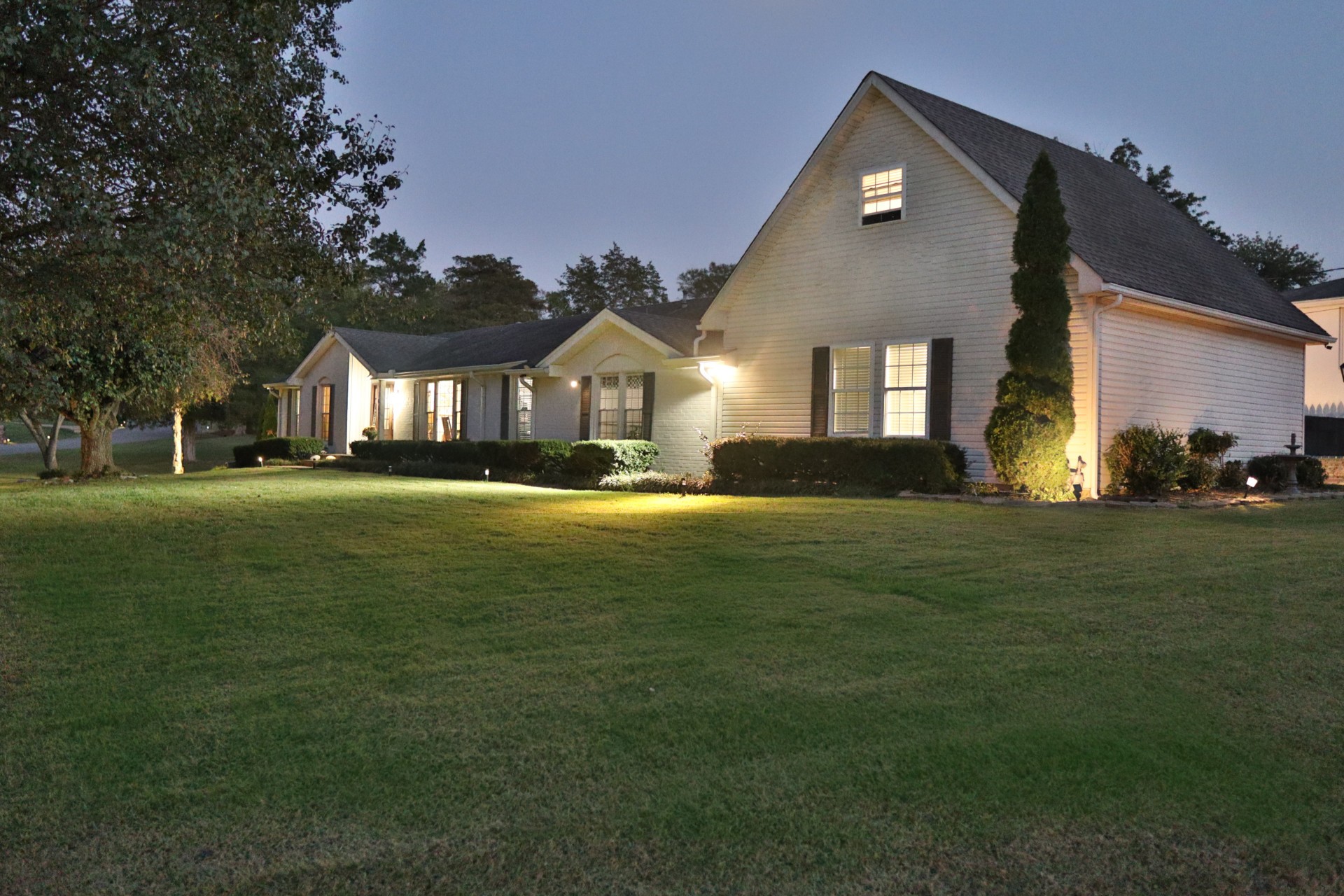 a front view of a house with a garden