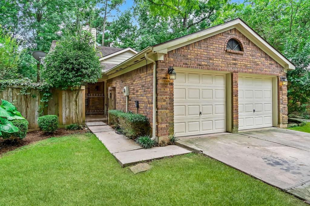 a front view of a house with a garden and yard