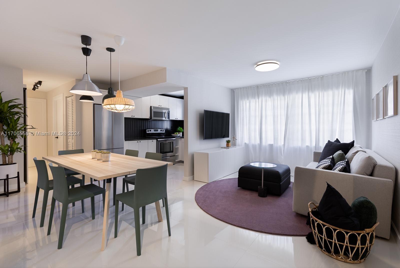 a living room with furniture a rug and a flat screen tv