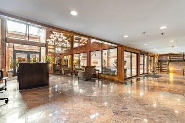 a lobby with furniture and floor to ceiling window