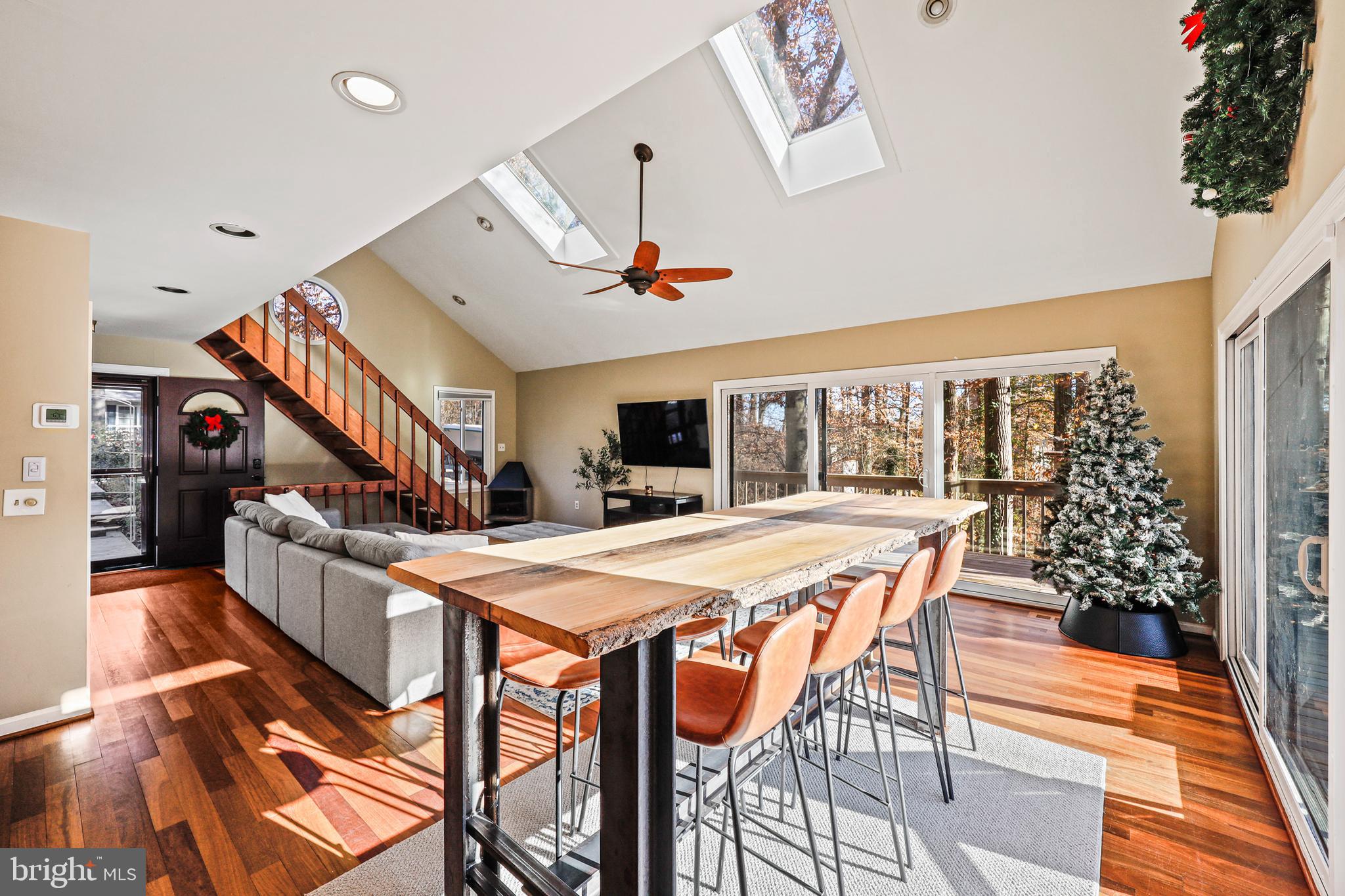 a dining room with furniture and a floor to ceiling window