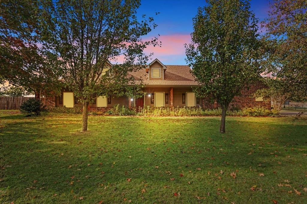 a front view of a house with a big yard