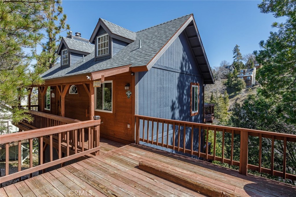 a view of a house with wooden deck