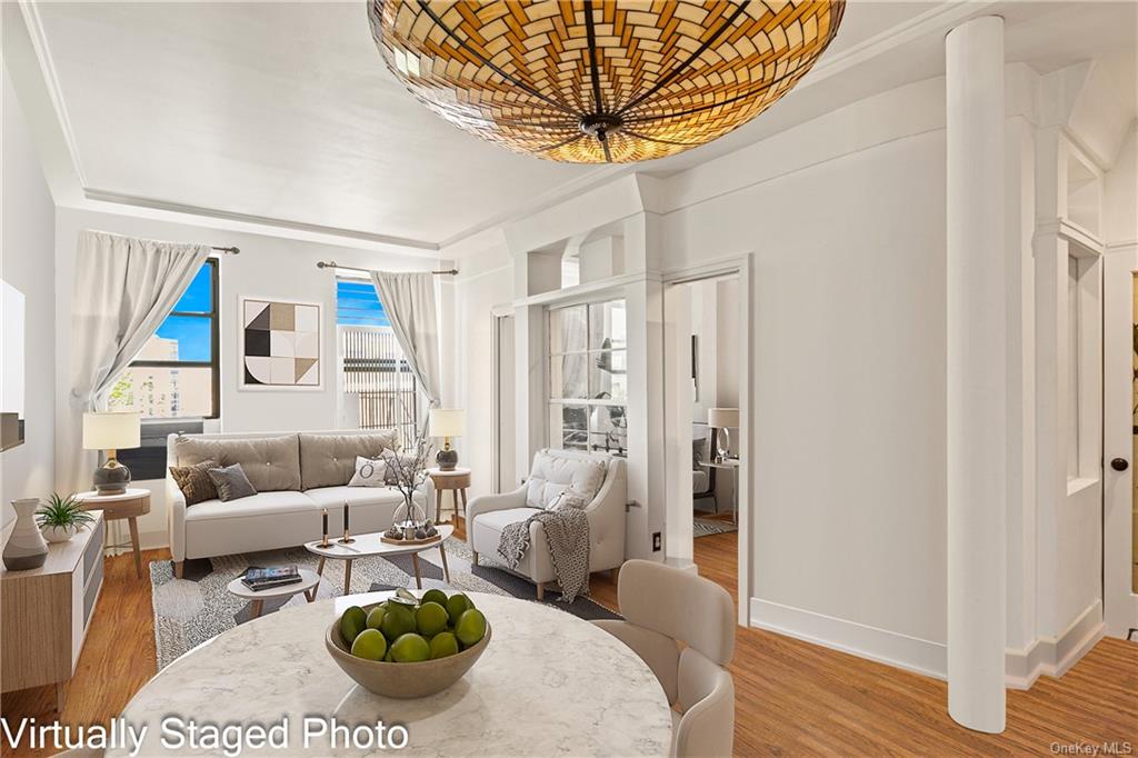 a living room with furniture a rug and a chandelier