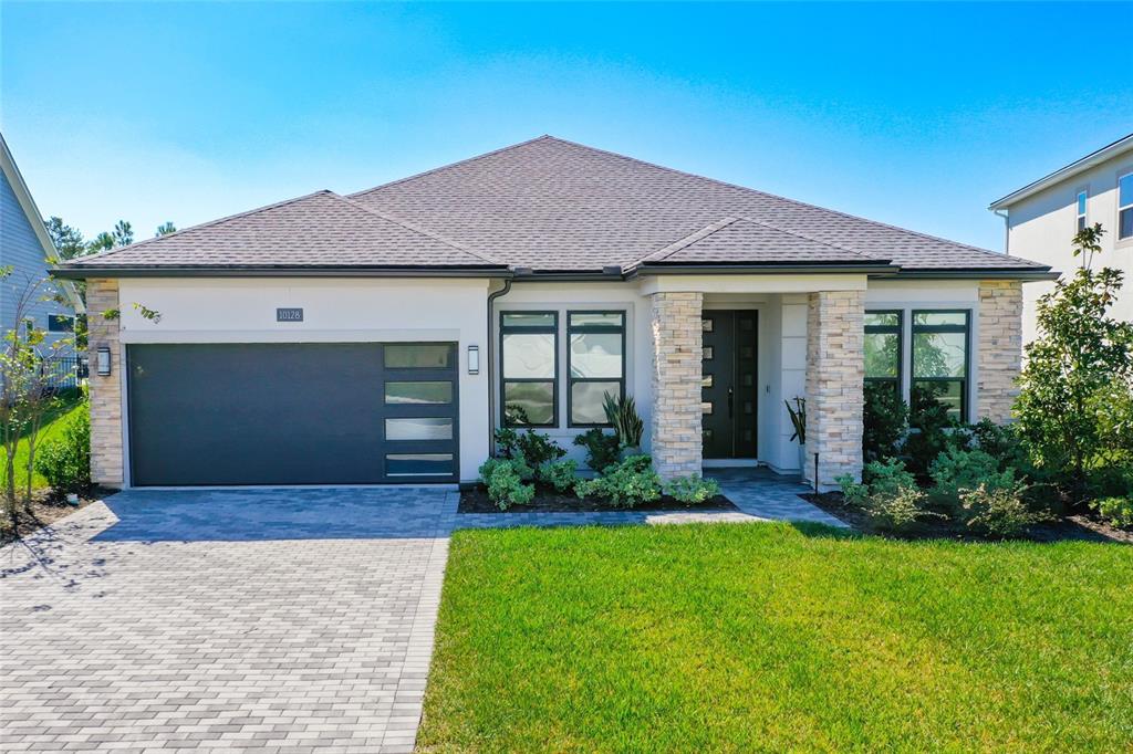 a front view of a house with a yard and garage