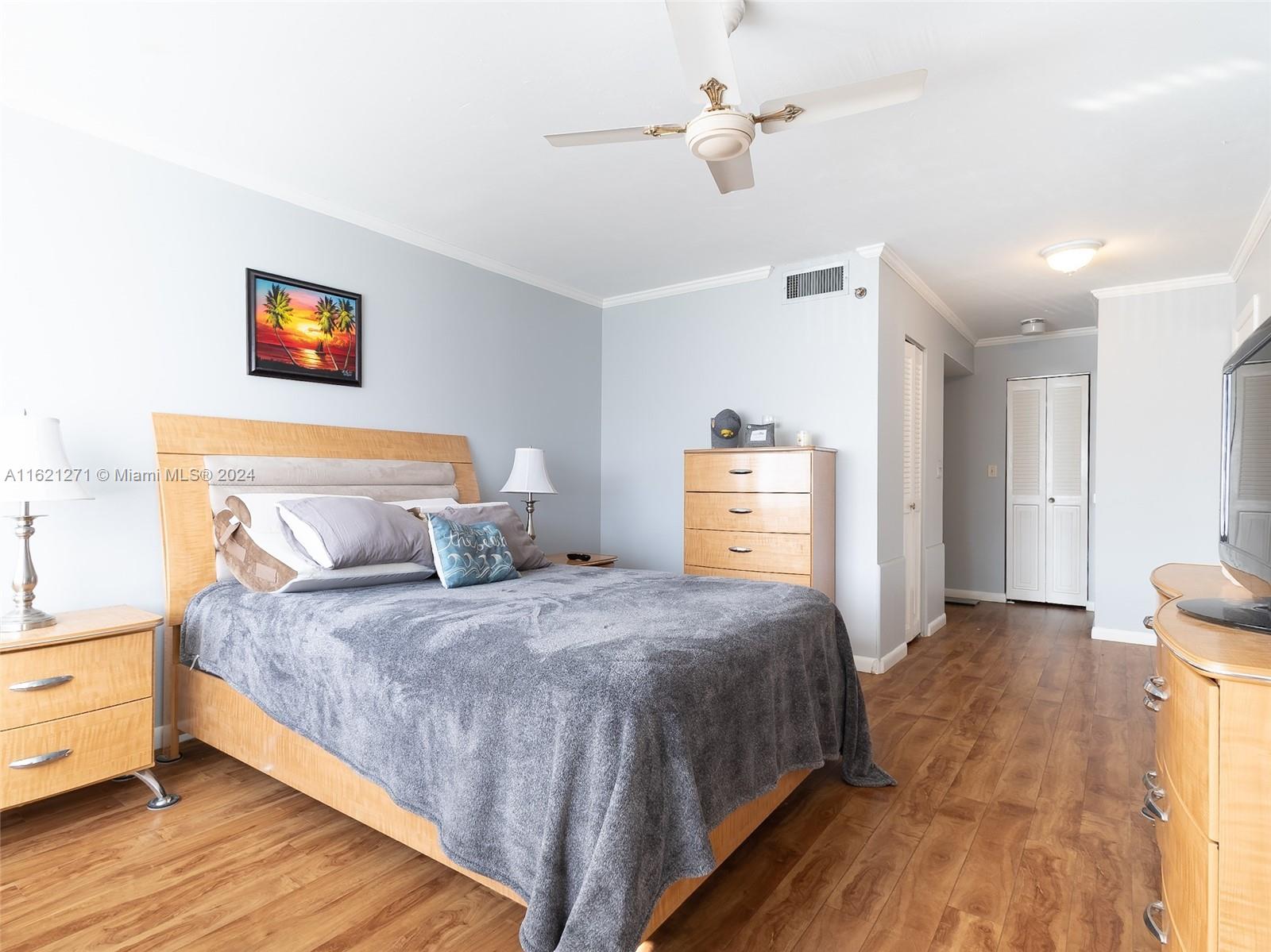 a bedroom with bed and wooden floor