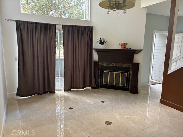 a view of an empty room with a fireplace and a window