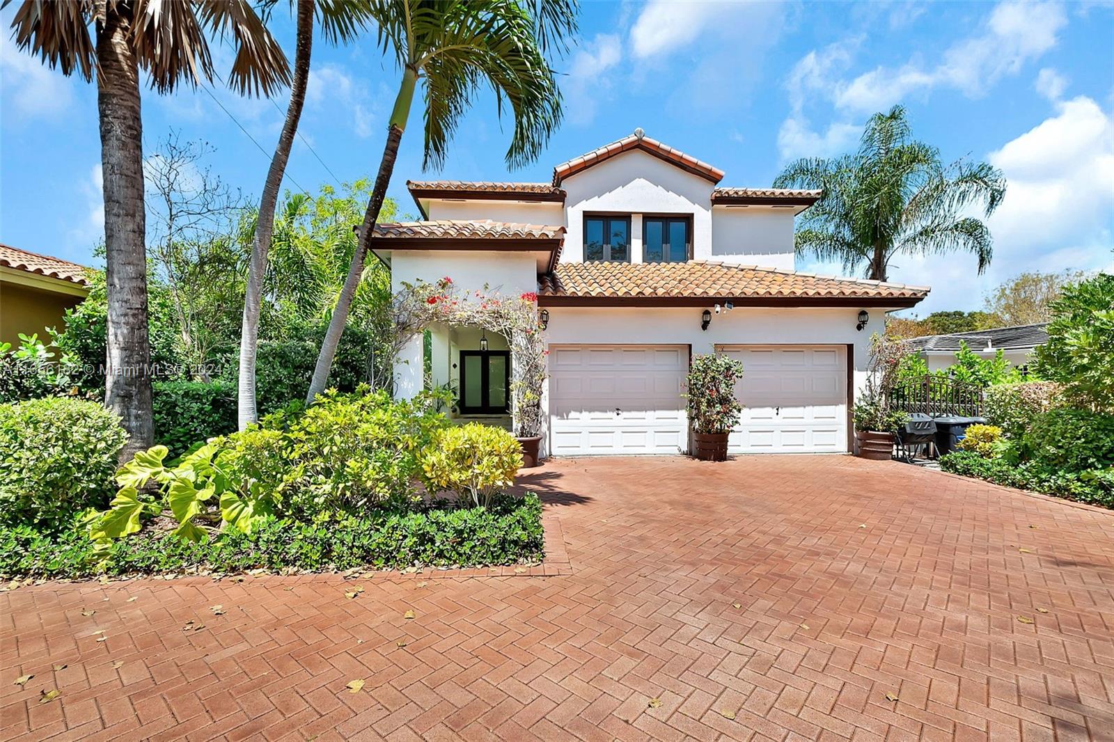 a front view of a house with a garden