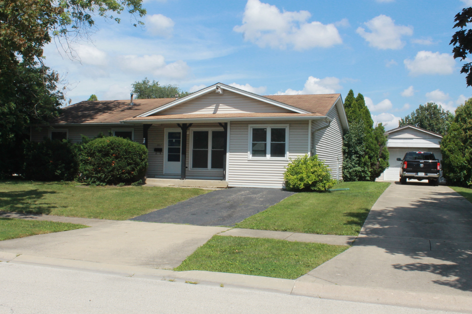 a front view of a house with a garden