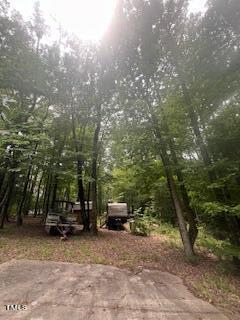 a view of car parked on road with trees