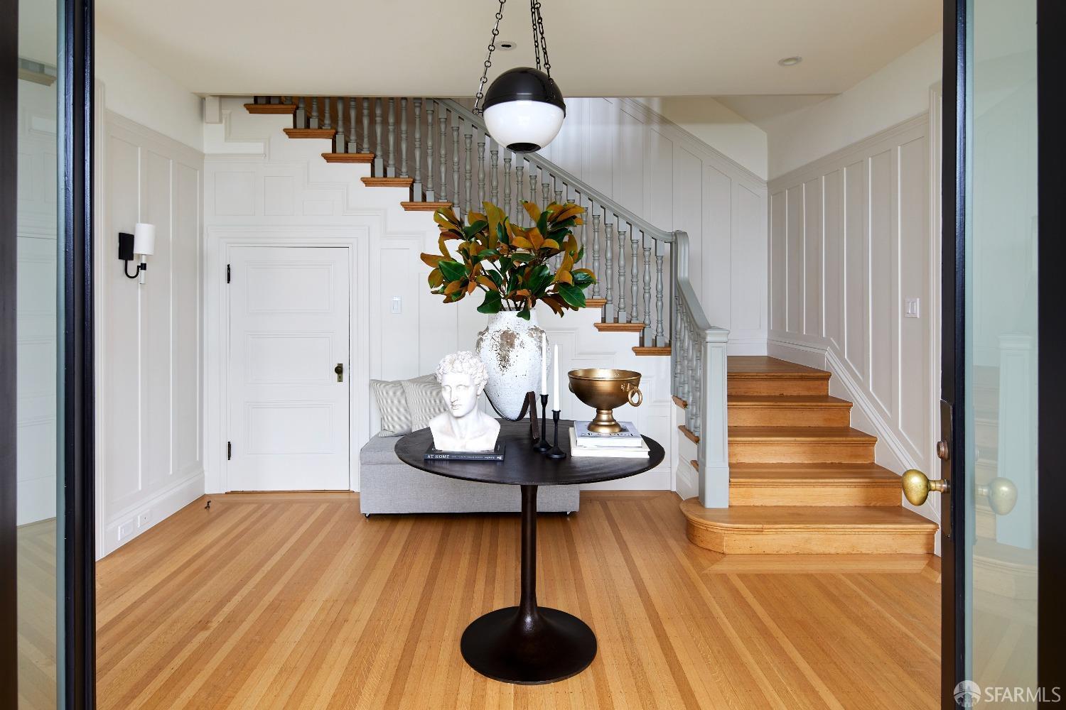 a view of entryway and hall with wooden floor