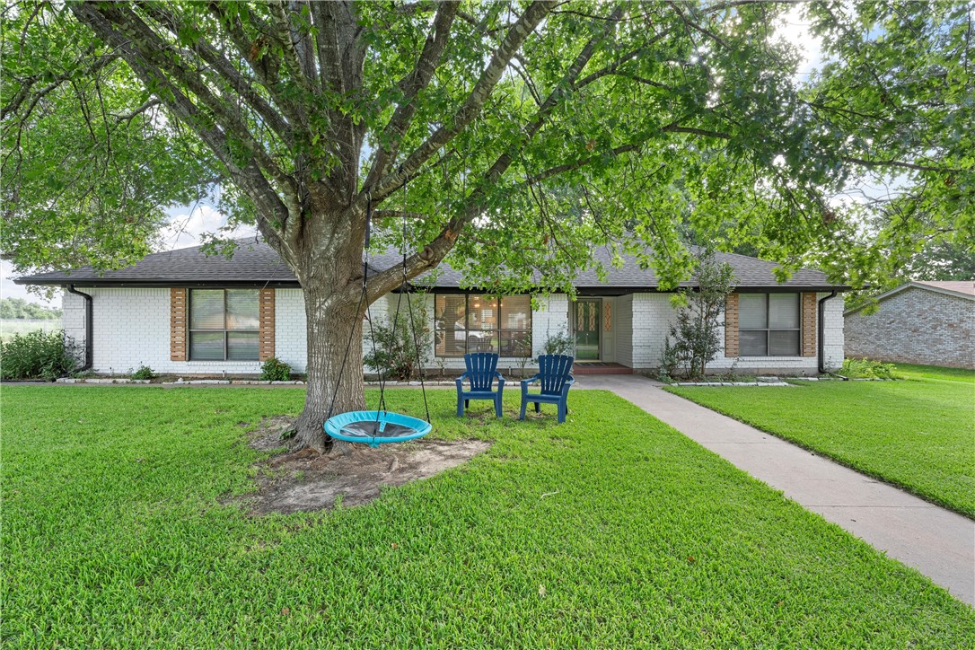 a house view with a sitting space garden and patio