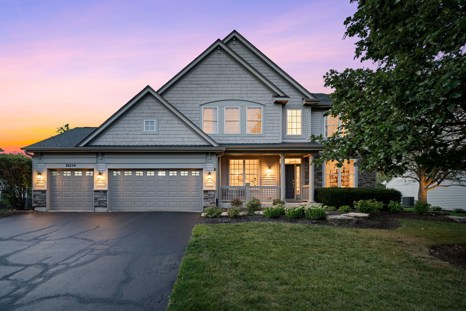 a front view of a house with a yard and garage