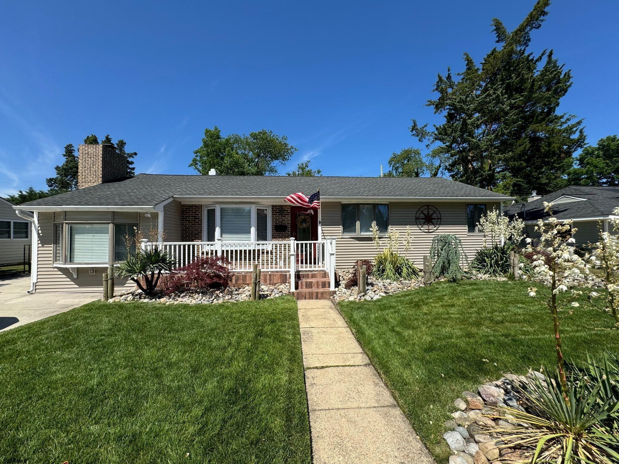 a front view of a house with a garden