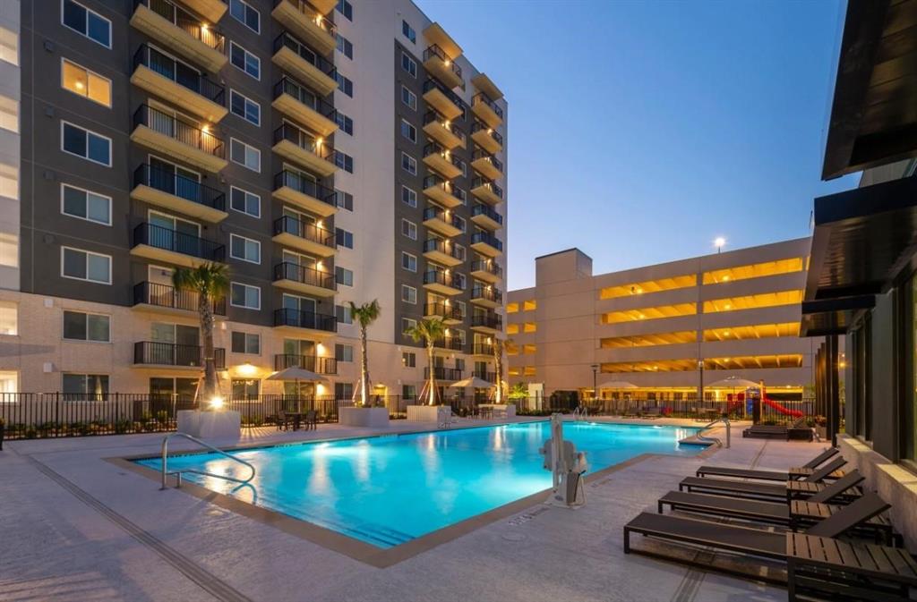 a view of a swimming pool with lawn chairs