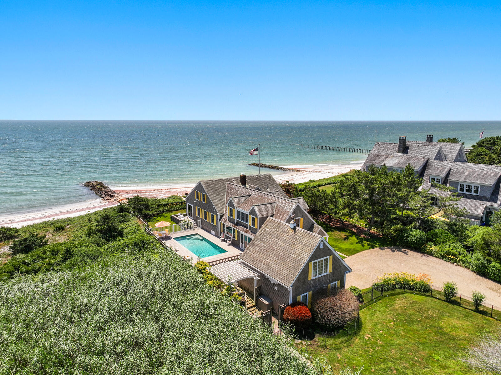 an aerial view of a house with a garden and lake view