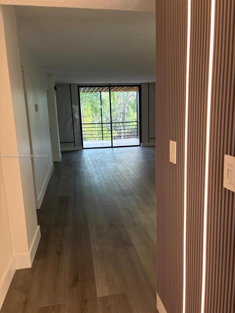 a view of a room with wooden floor and walls