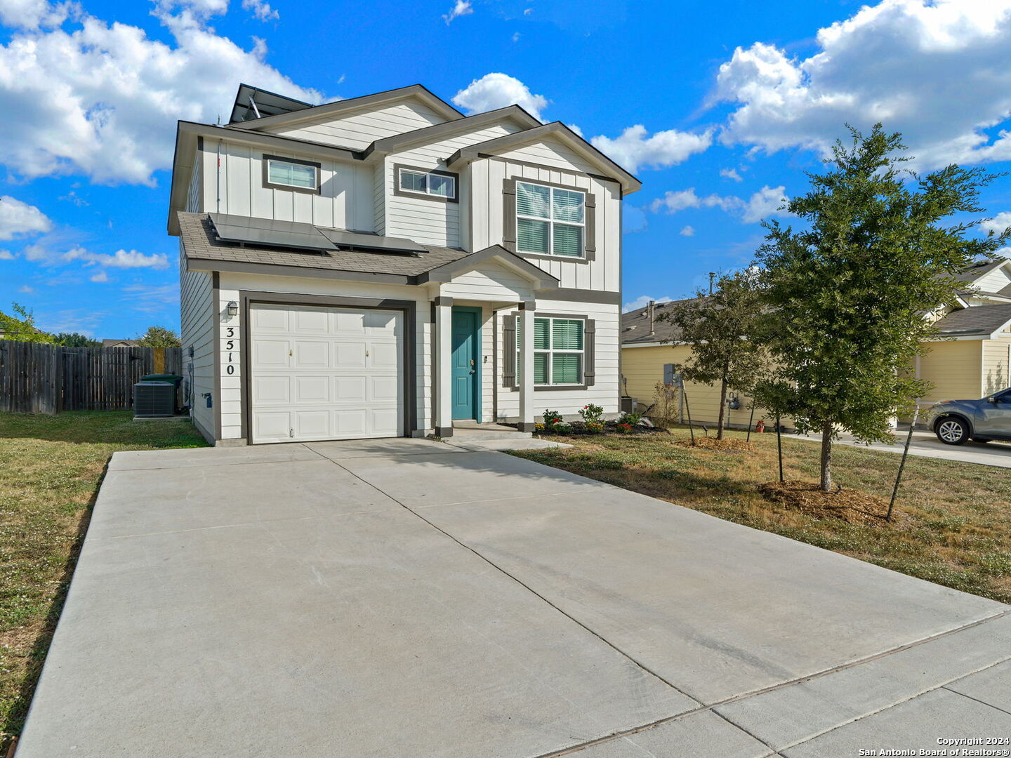 a front view of a house with a yard and garage