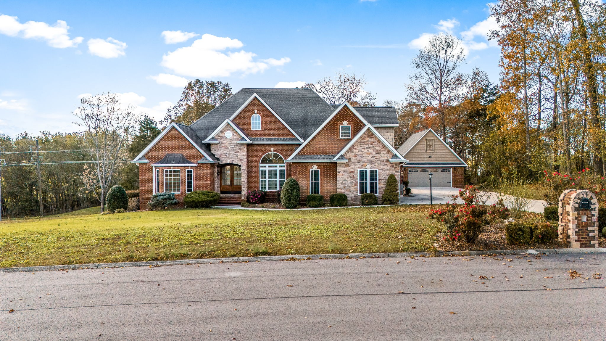 a front view of a house with a yard and garage