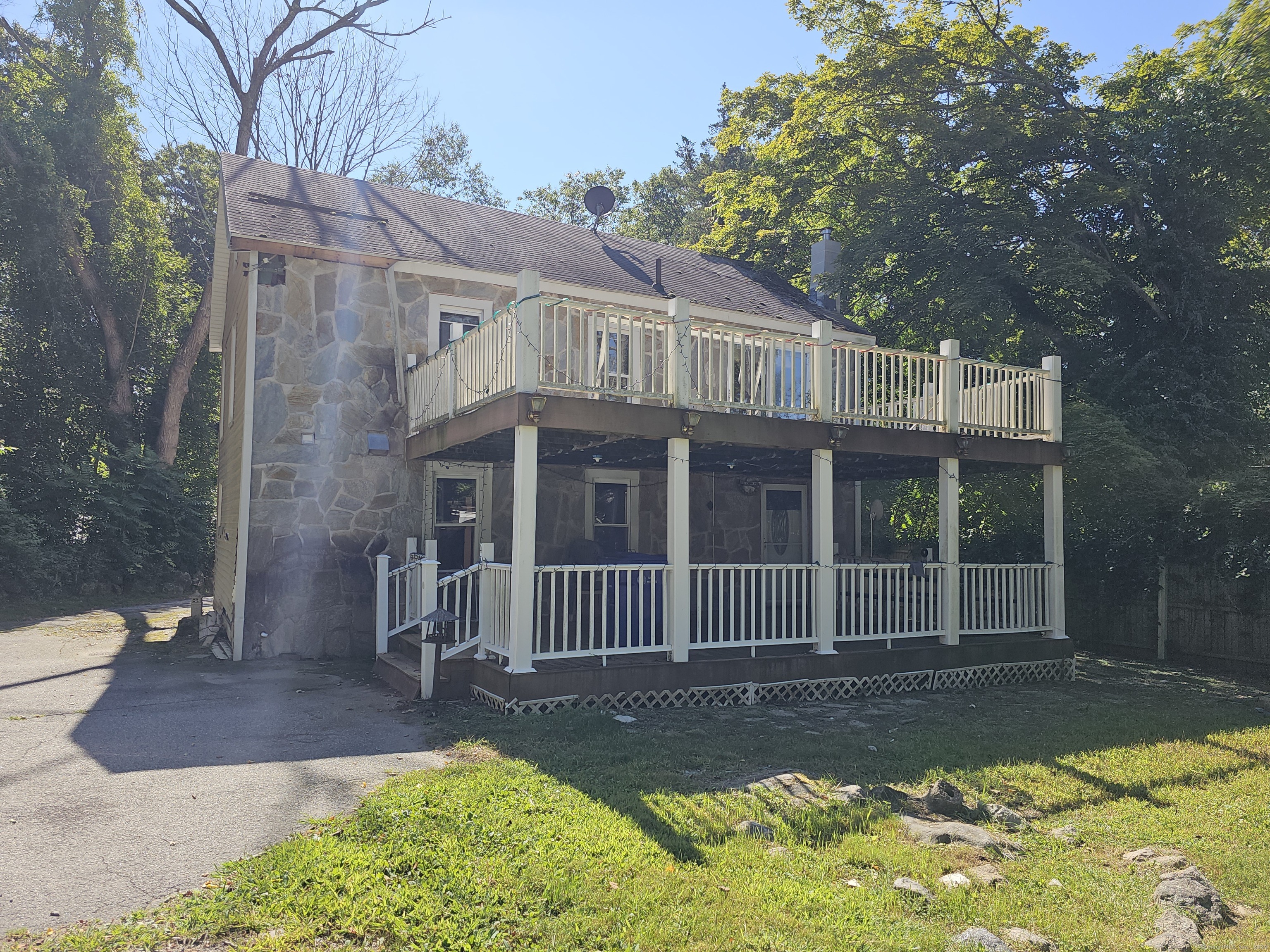 a view of a house with a yard and porch