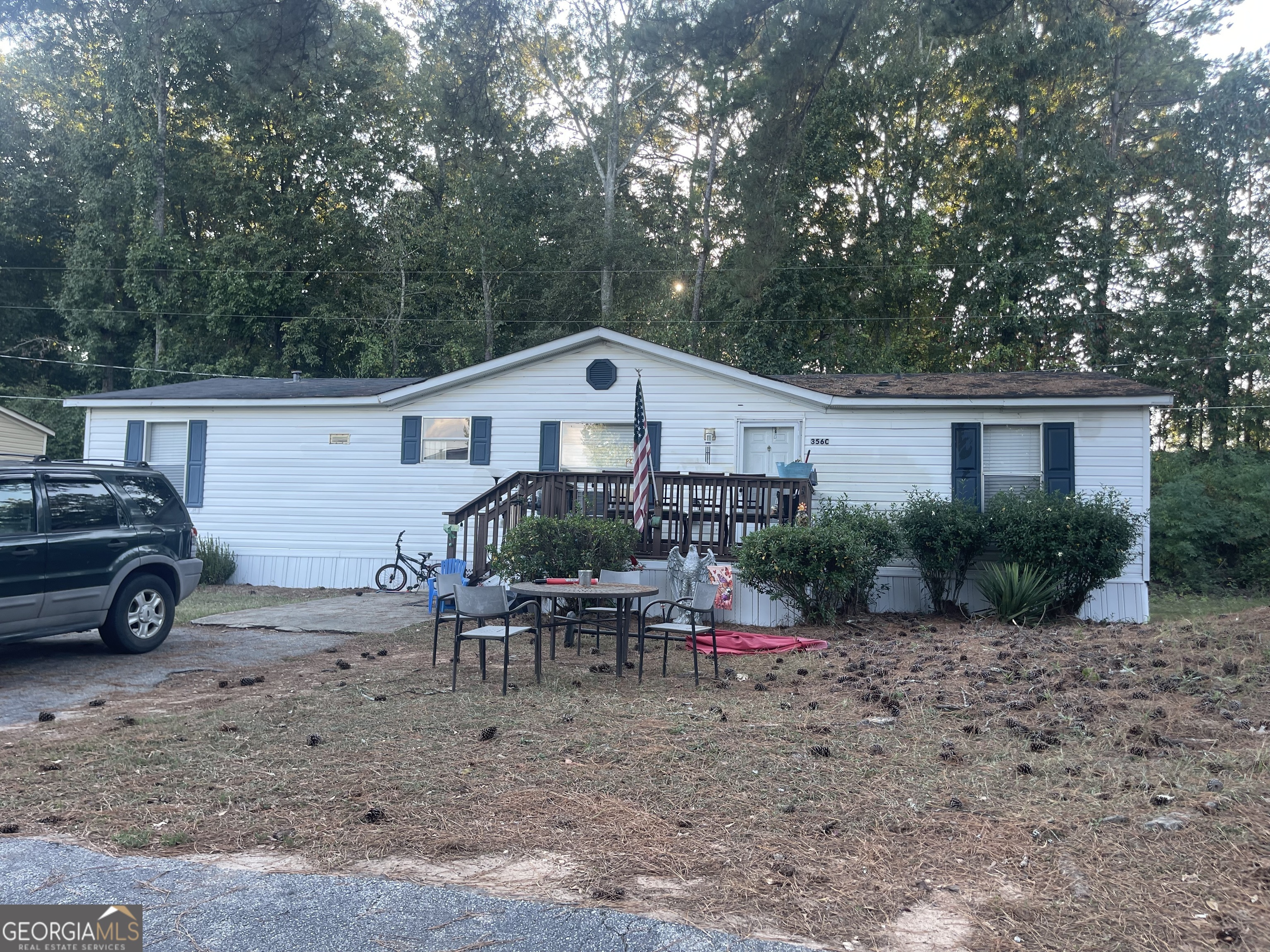 a view of a house with a yard and sitting area