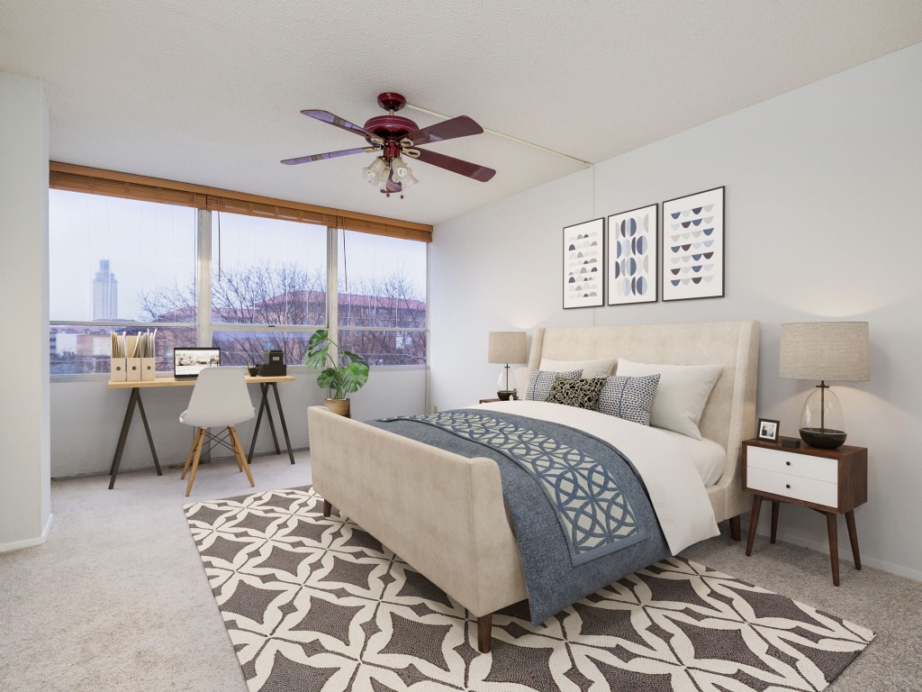 a living room with a bed and a chandelier