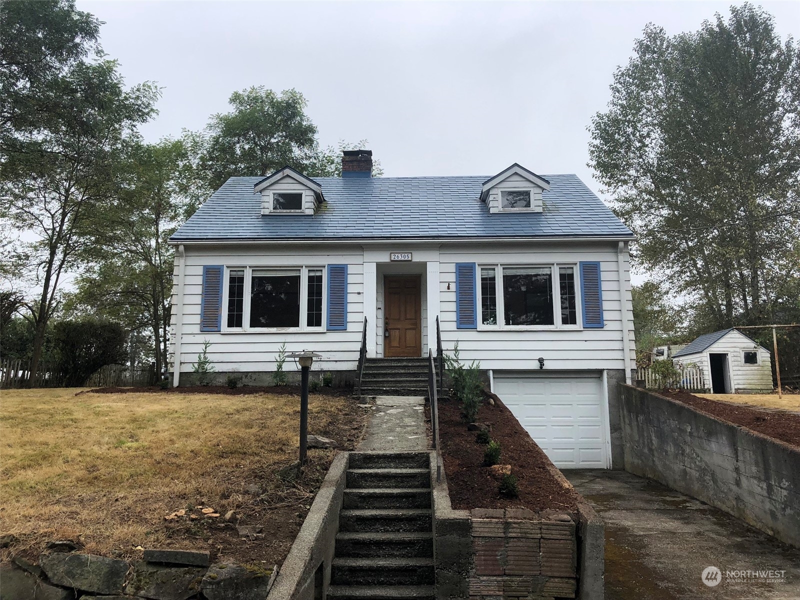 a front view of a house with yard