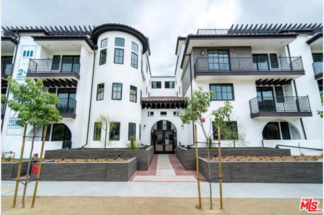 front view of a house with a fountain