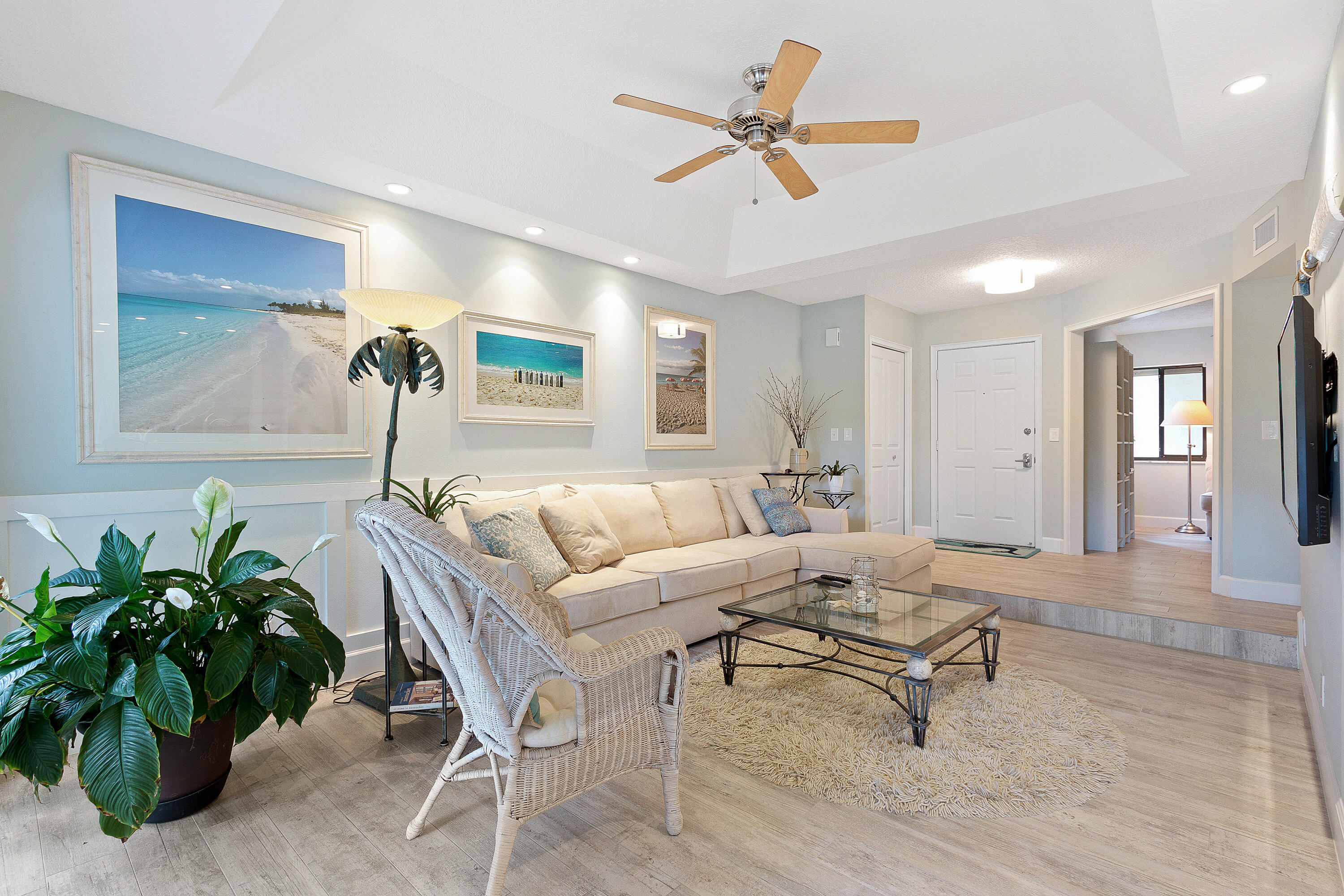 a living room with furniture and a potted plant