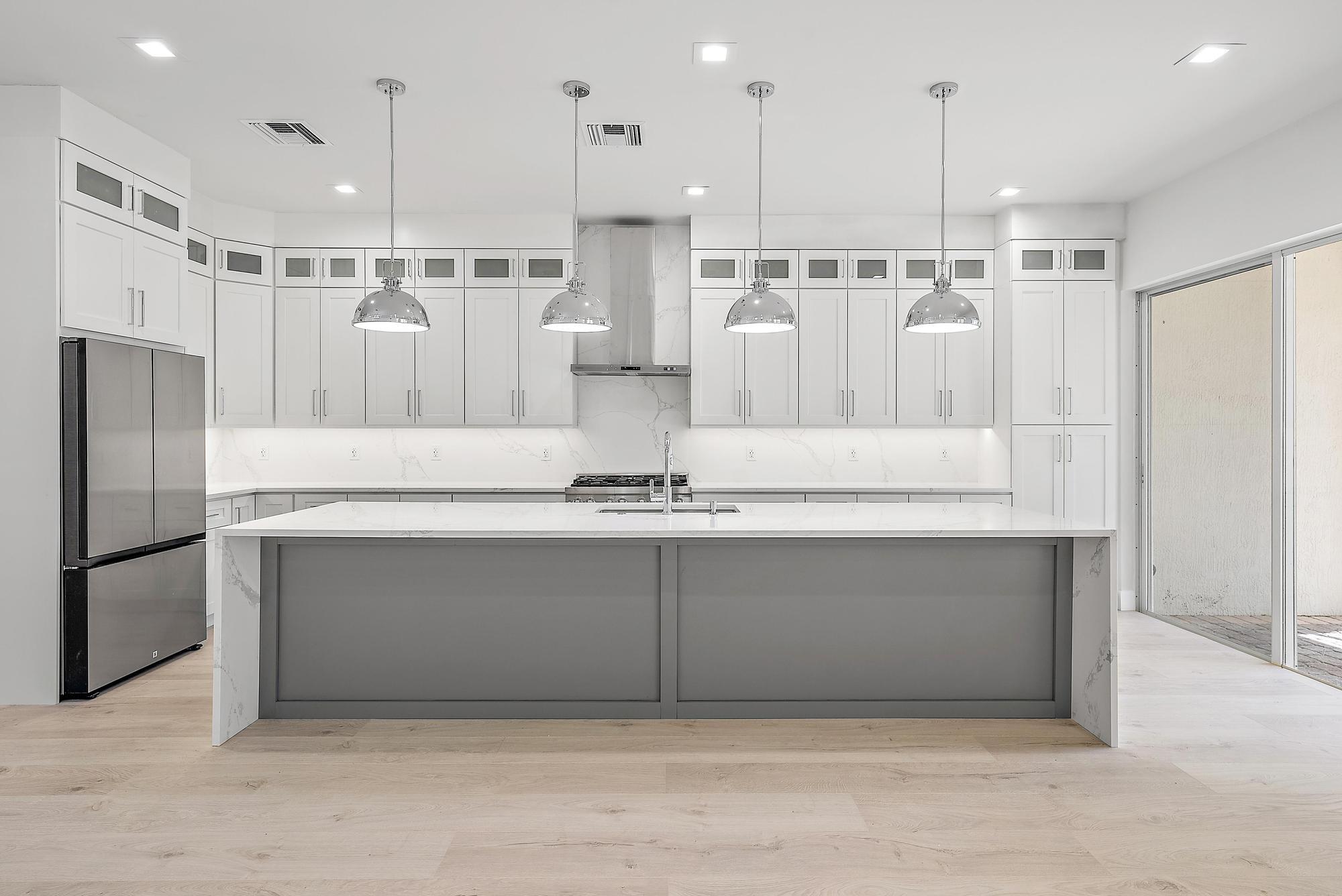 a view of kitchen with stainless steel appliances refrigerator oven and cabinets