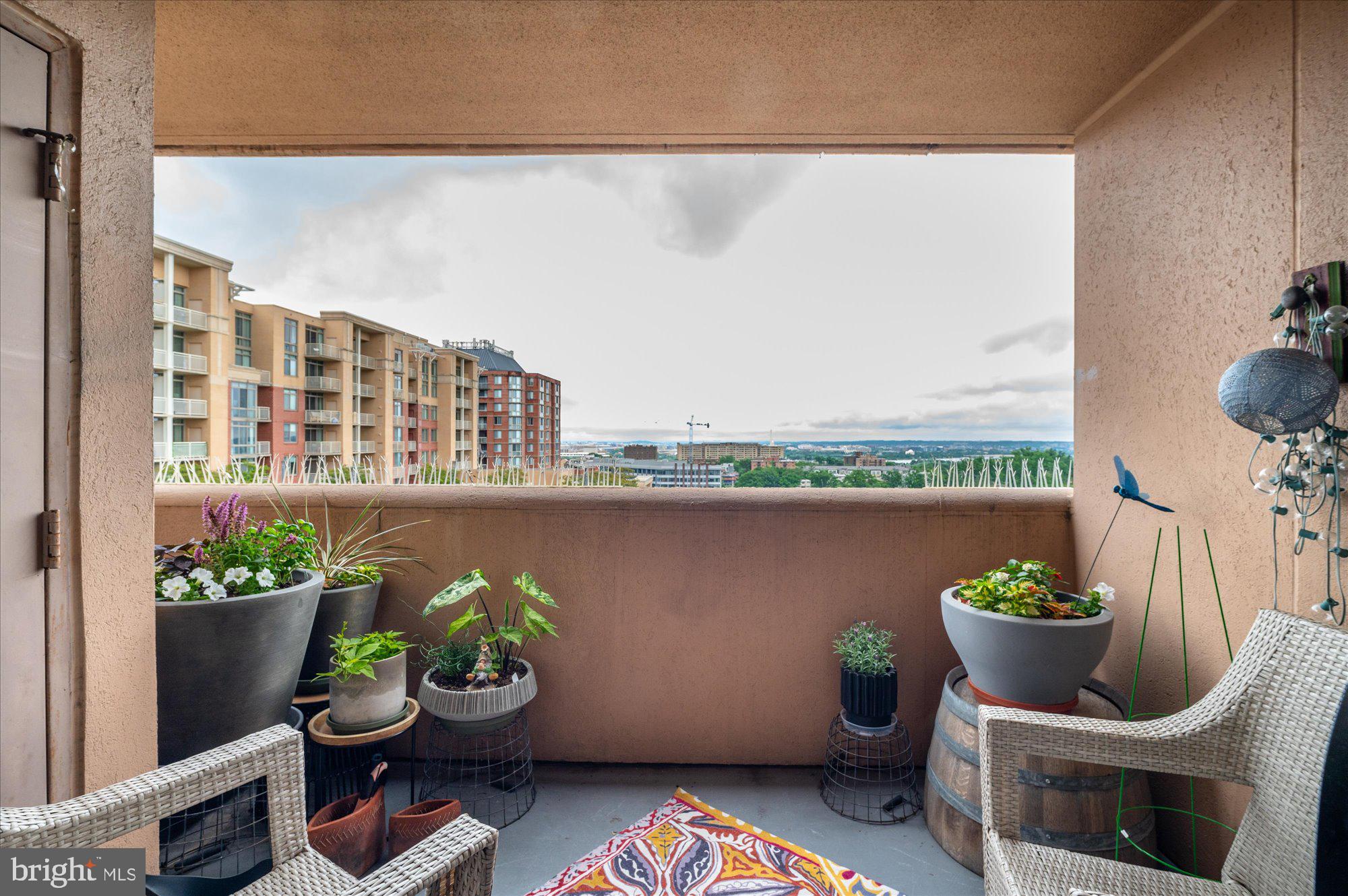 a view of a balcony with chair and potted plant