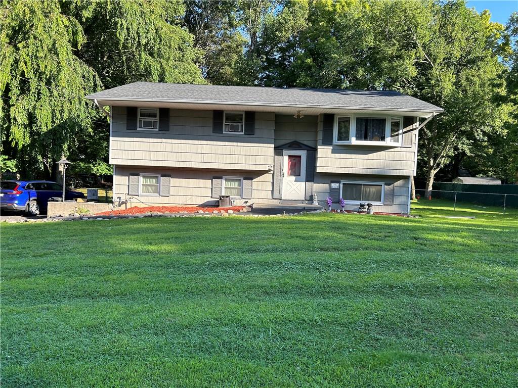 Raised ranch with a front yard