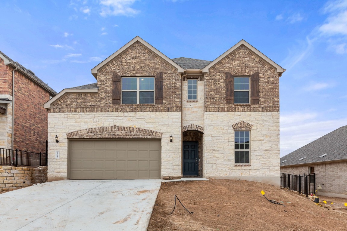 a front view of a house with garage