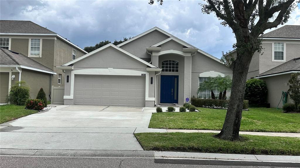 a front view of a house with a yard and garage